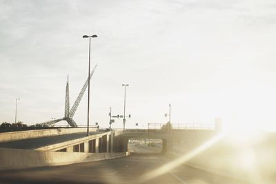 Bridge over street against sky in city