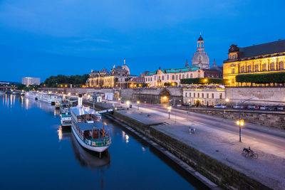 Boats on river in city at night