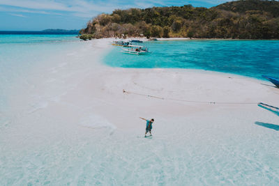 Drone view of man at beach on sunny day