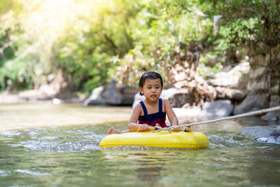 Little girl playing at mountain stream