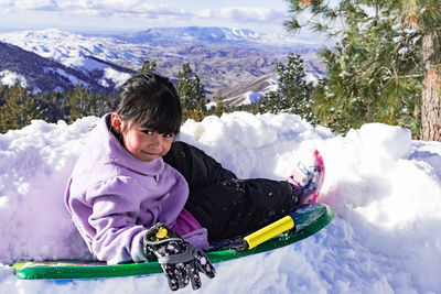 Full length of child on snowcapped mountain during winter