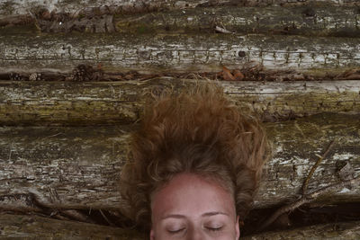 Close-up of young woman on logs