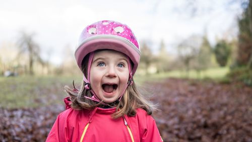 Portrait of smiling girl against pink sky