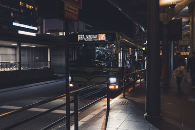 Train at railroad station platform at night