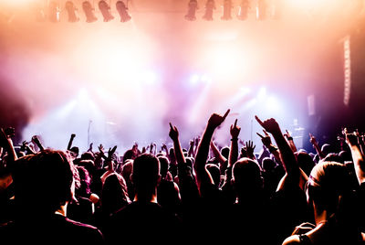 Crowd with arms raised during concert