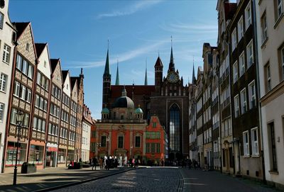 Street amidst buildings against sky in city