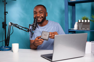 Portrait of blogger blogging at studio