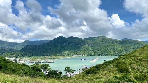 Scenic view of river and mountains against sky