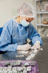 Scientist preparing paraffin blocks containing biopsy tissue for sectioning. pathology laboratory.