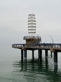 Lifeguard hut on sea against sky