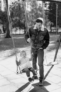 Full length of boy swinging at playground