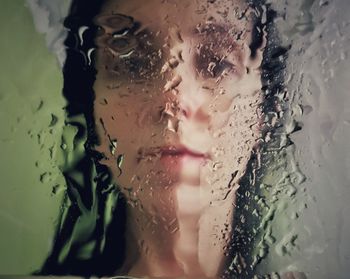 Close-up portrait of wet glass window during rainy season