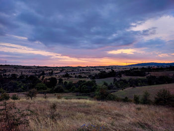 Scenic view of field against sky during sunset