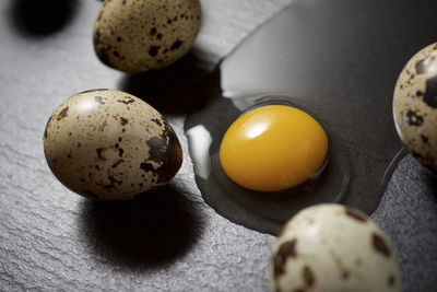 Quail eggs on a black table.