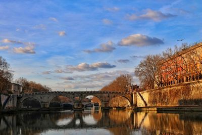 Bridge over river with buildings in background