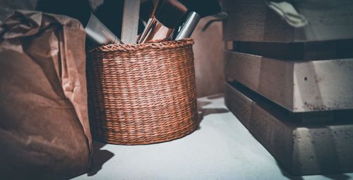 Close-up of wicker basket on shelf at home