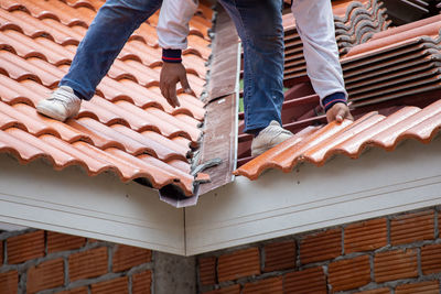 Low section of people standing on roof