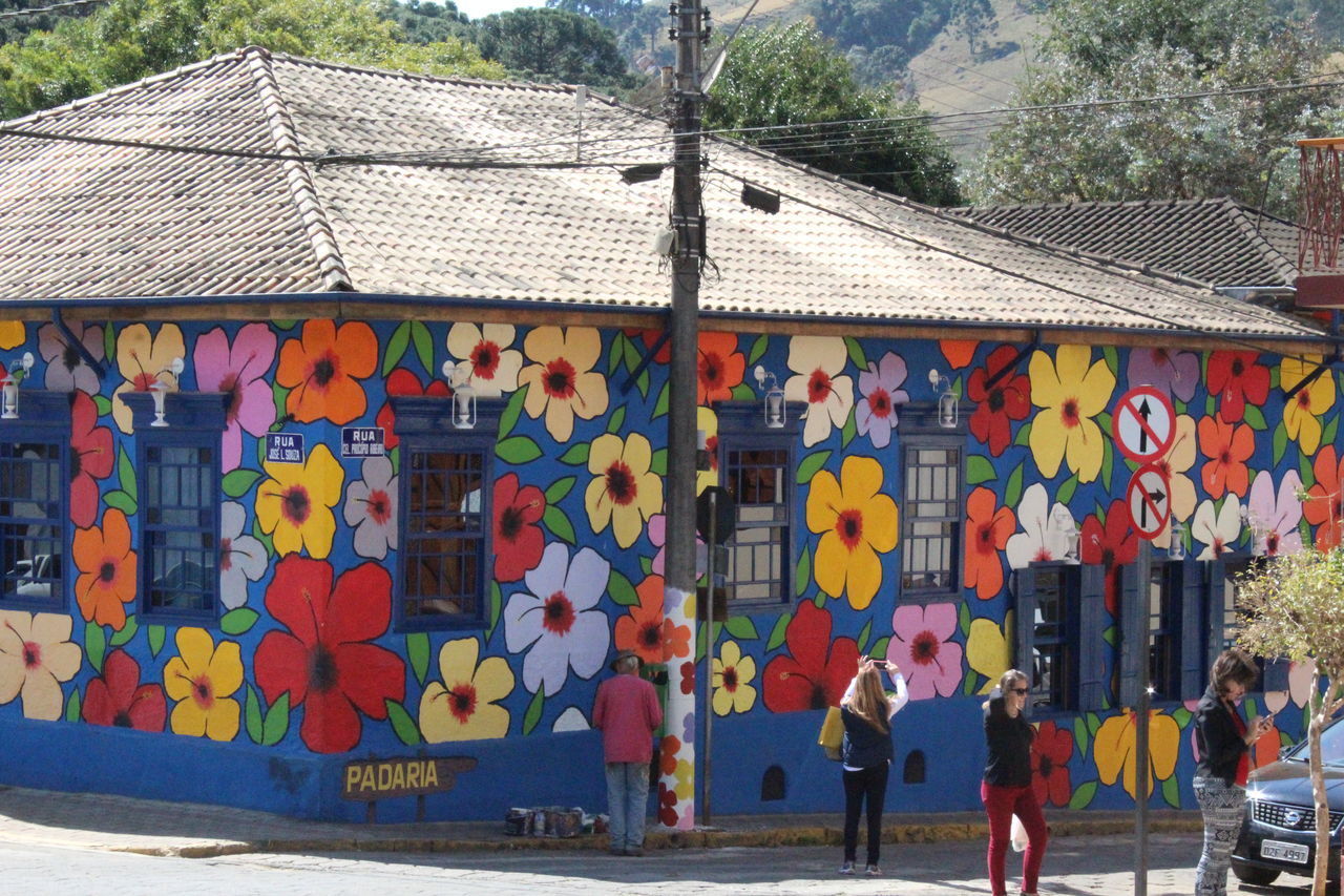 PEOPLE WALKING ON MULTI COLORED BUILDING