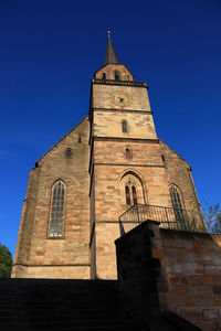 Low angle view of historic building against clear blue sky