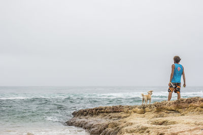 Rear view of man standing on beach