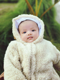 Portrait of cute baby girl in warm clothing outdoors