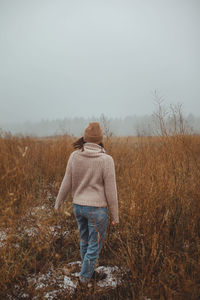 Rear view of man standing on snow covered land