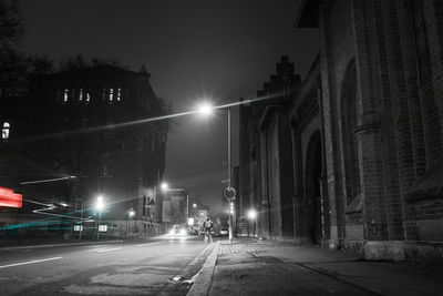 Illuminated road in city at night