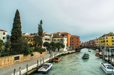 Boats in river with buildings in background