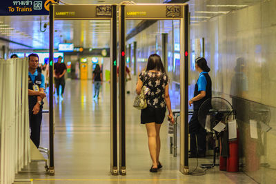 Rear view of women walking in airport