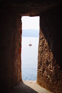 Scenic view of sea against sky seen through window