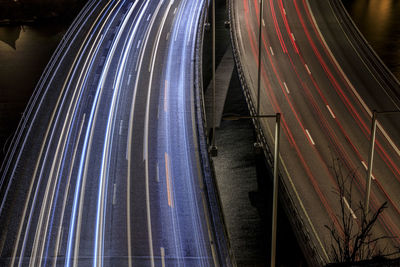 Low angle view of light trails on highway at night