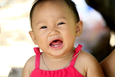 Portrait of cute baby girl crying outdoors