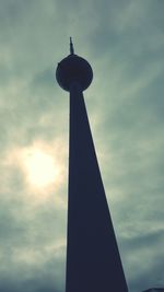 Low angle view of tower against cloudy sky