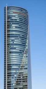 Low angle view of skyscraper against clear blue sky