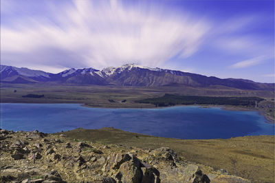 Scenic view of lake and mountains against sky