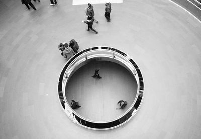 High angle view of people walking on floor