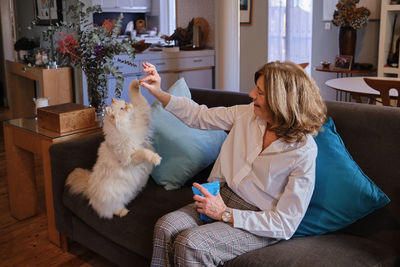 Woman using mobile phone at home