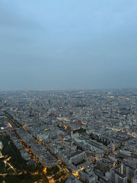 High angle view of city by sea against sky