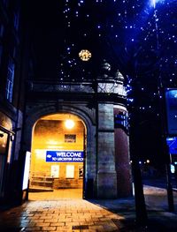 Illuminated underground walkway at night