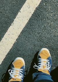 Low section of person standing on road