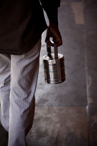 Cropped image of man holding lunch box