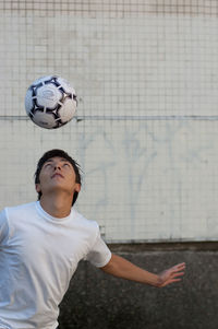 Young man playing with soccer ball