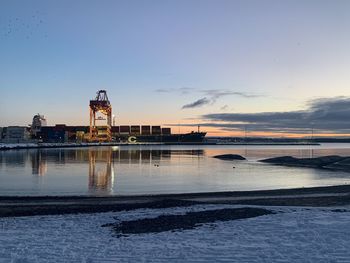 Scenic view of seaport against sky during sunrise 