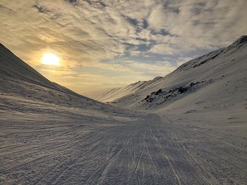 Scenic view of snow covered mountains against sky during sunset