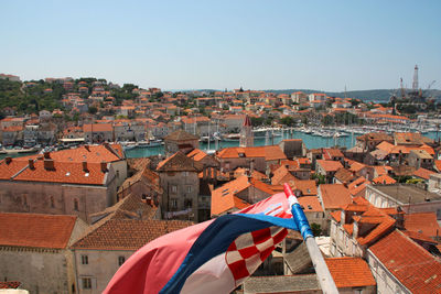 High angle view of flags in city against clear sky