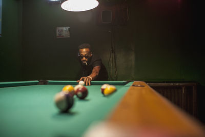 A young woman playing pool.