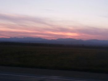 Scenic view of mountains against sky at sunset