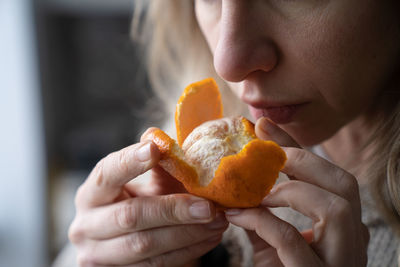 Close-up of woman holding orange