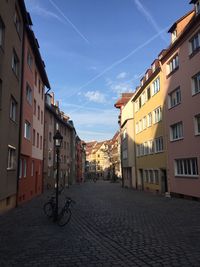 Street amidst buildings against sky