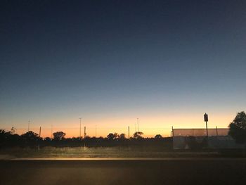 Road against clear sky at sunset